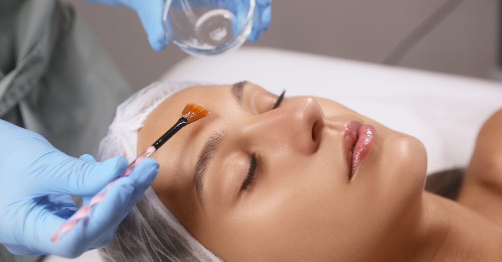 Woman receiving a chemical peel treatment. Not a real patient.