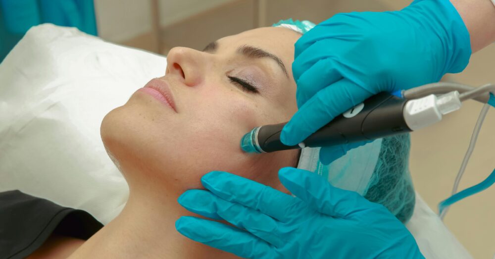Aesthetician performing a facial treatment on a female client at a med spa