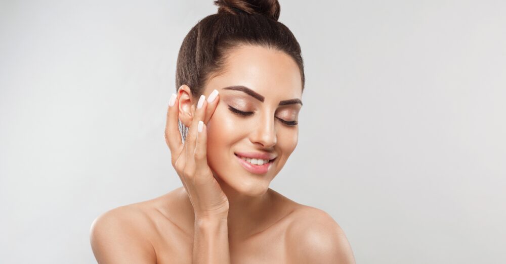 Woman with radiant, smooth skin smiling after a DiamondGlow skin resurfacing treatment