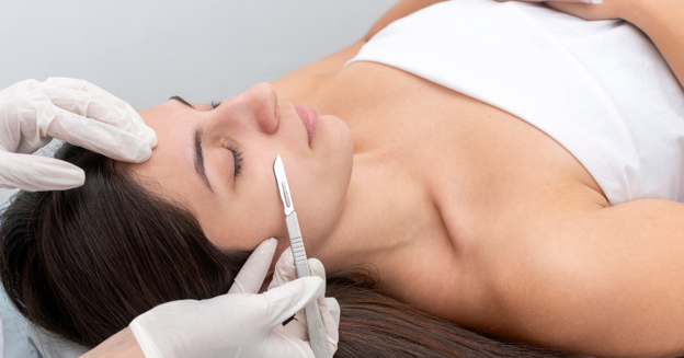 A woman receiving a dermaplaning treatment