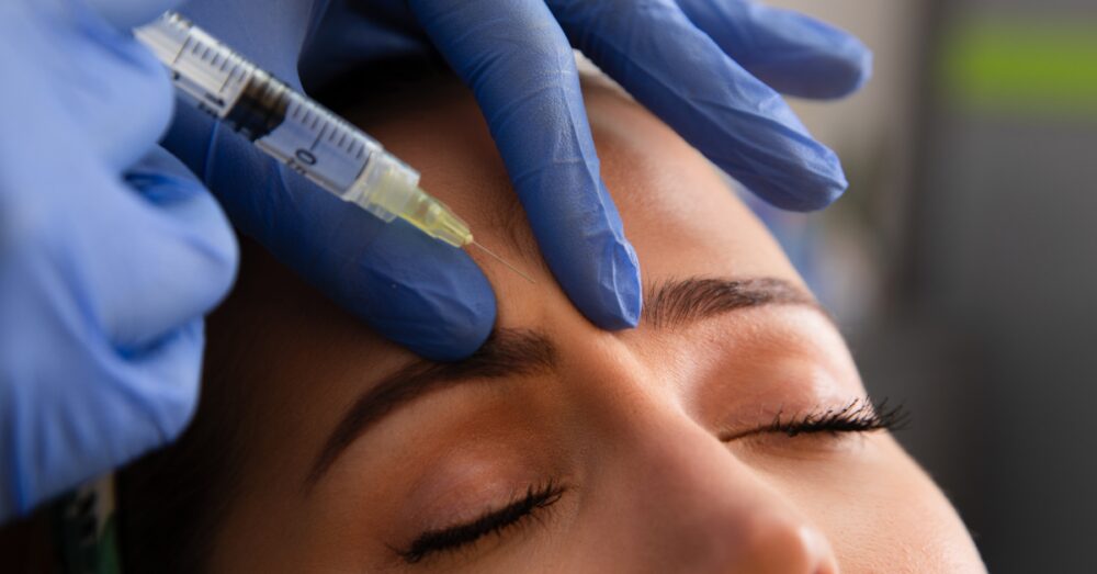Woman receiving Botox injections between her brows