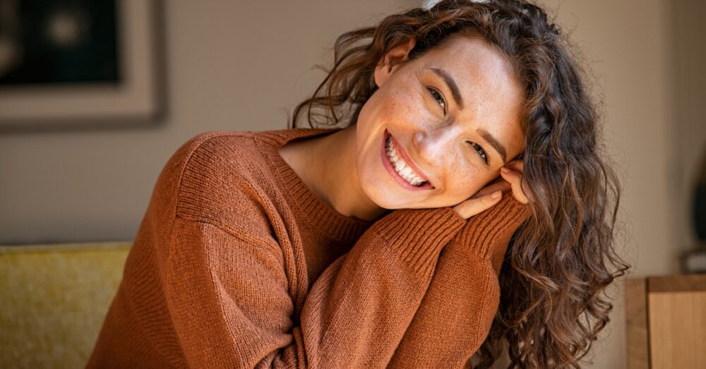 Woman in a brown sweater smiling