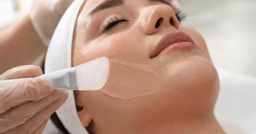 Close up image of a woman receiving a chemical peel treatment in a clinical setting